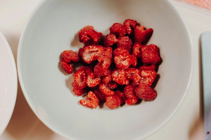 sliced strawberry fruits in round white bowl
